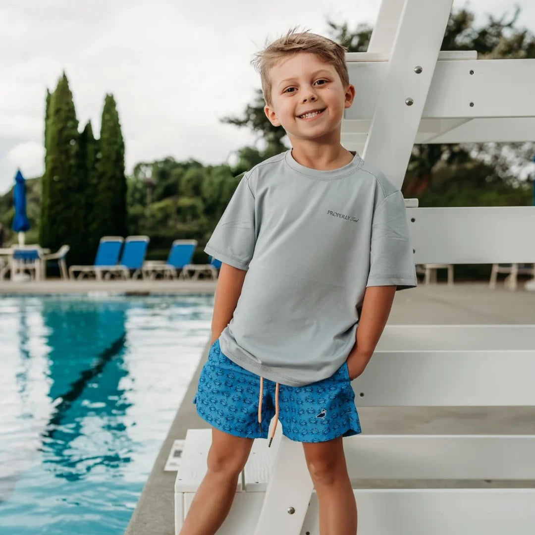 boy smiling by the pool