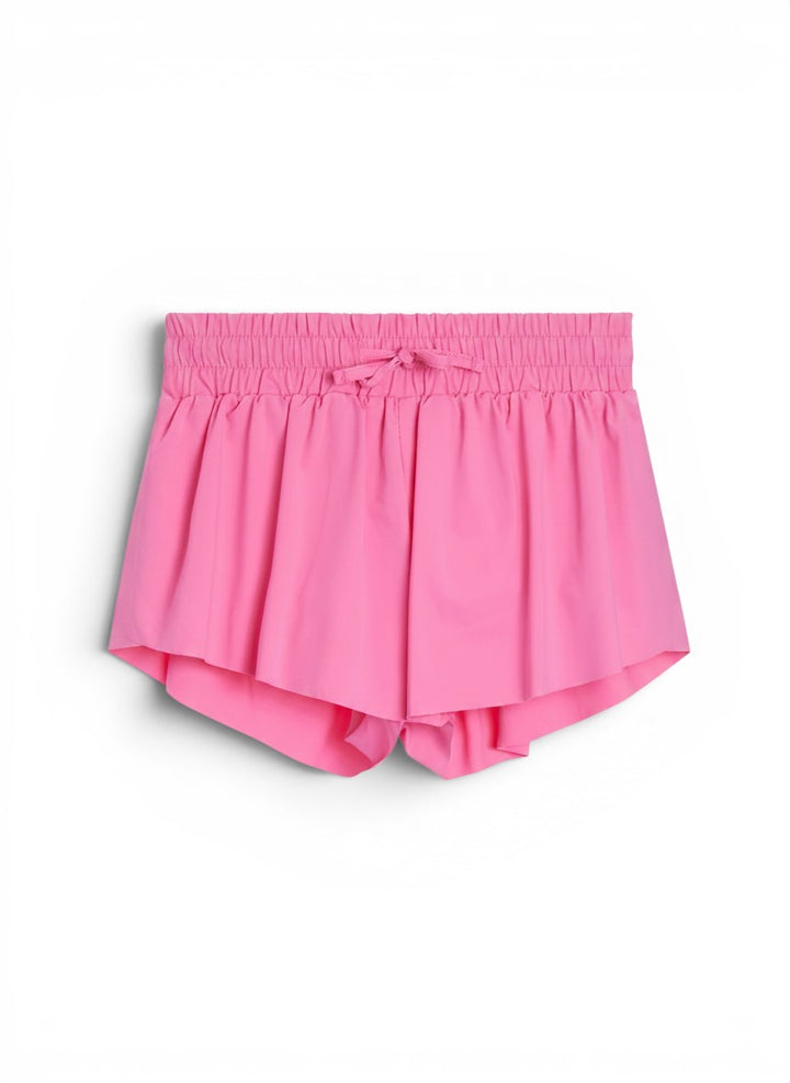 Vann &amp; Liv Suzette Fly Away shorts in bubble gum pink. Pleated design with elastic waistband and drawstring. Built-in compression shorts.
