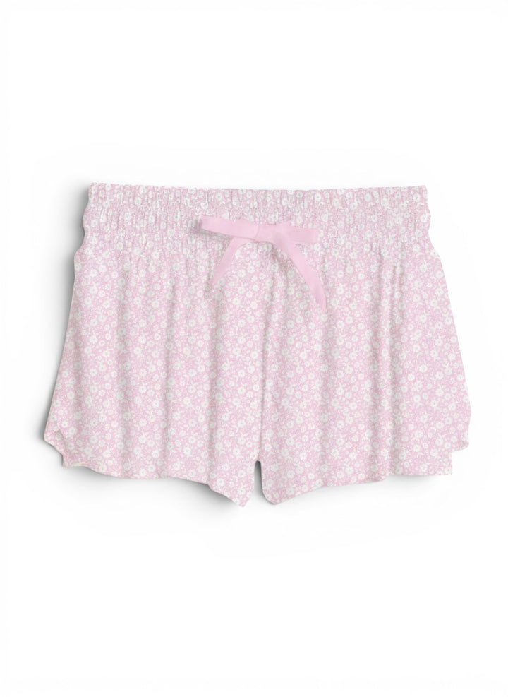 Vann &amp; Liv blush pink floral print shorts with smocked waistband and pink bow detail.