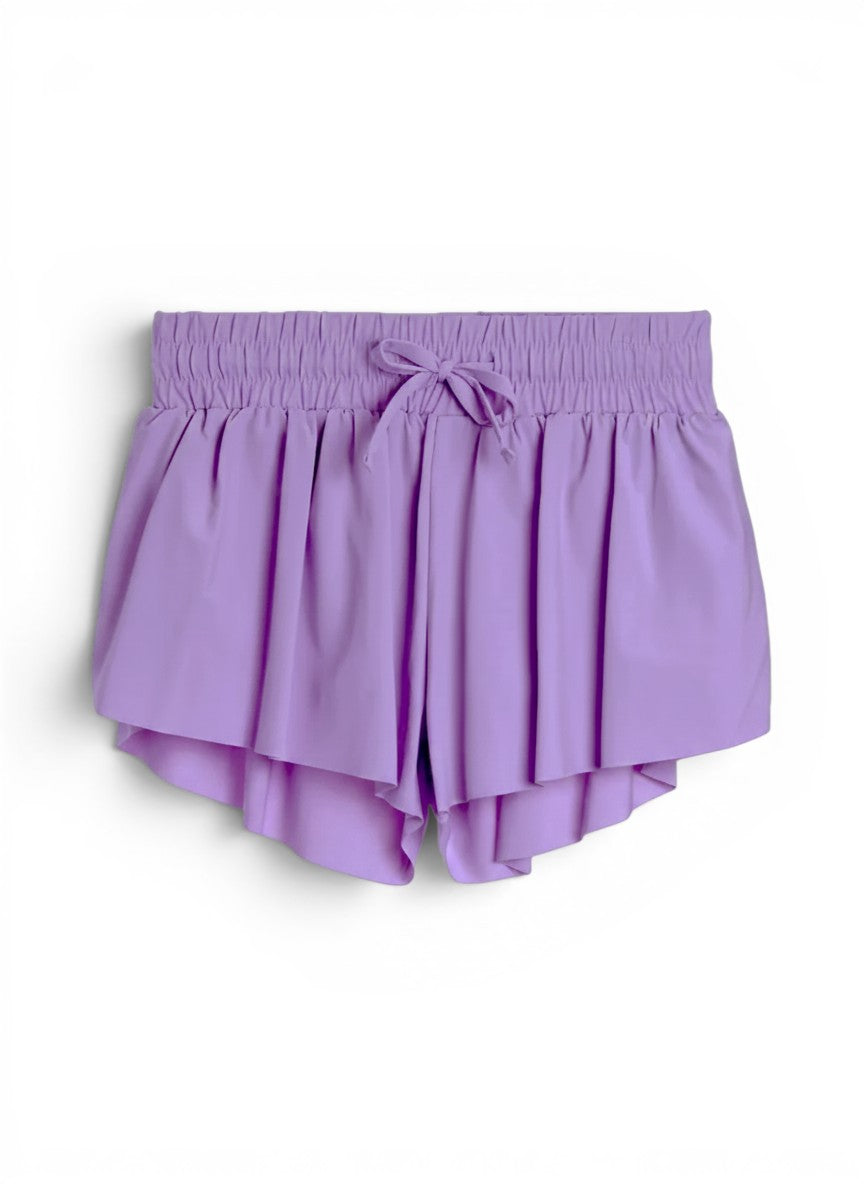 Vann & Liv Suzette Fly Away shorts in violet. Pleated design with elastic waistband and drawstring. Built-in compression shorts.